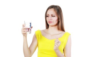 Woman with glass of bad well water