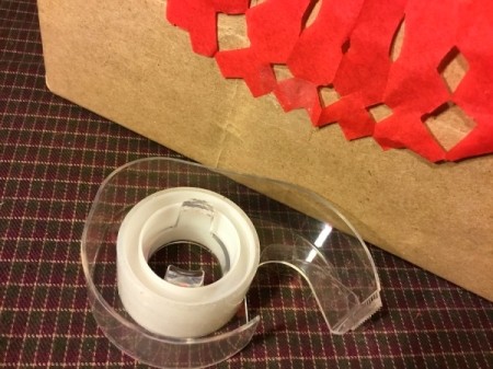 Thrifty Holiday Gift Wrapping - tape to top of wrapped package
