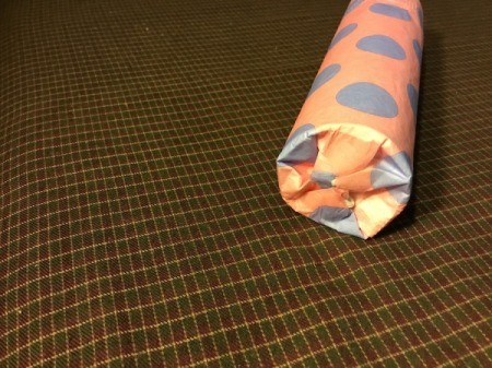 Thrifty Holiday Gift Wrapping - add gift and glue bottom shut, twist top and add a bow