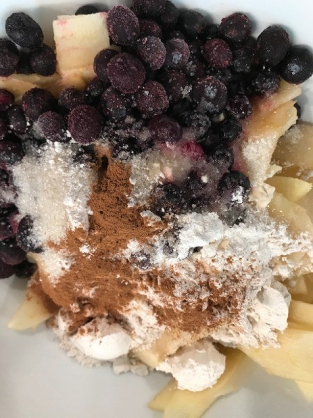flour, cinnamon and blueberries added to apples