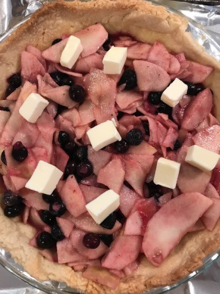 butter pats on pie filling