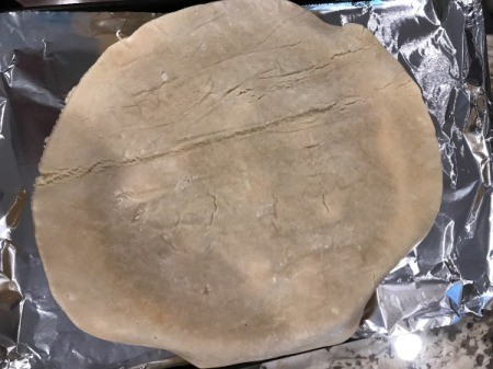 Pie crust added to top of pie