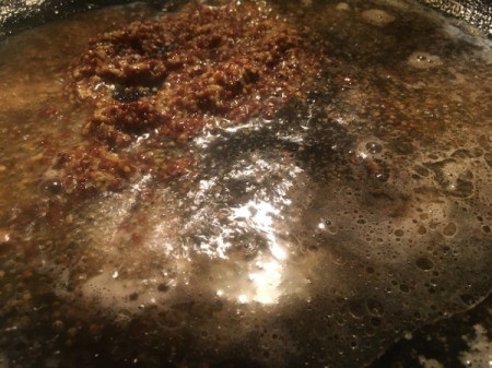 mustard and chicken broth in pan