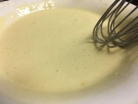 whisking egg in bowl