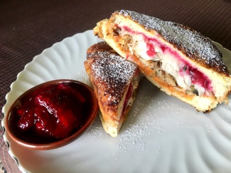 Thanksgiving Leftovers Monte sandwich with side of cranberries on plate