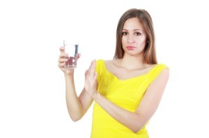 Woman Holding Glass of Smelly Water