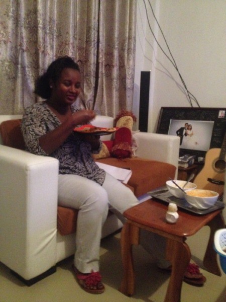 Couch Pillow and Curtain Color Advice - woman sitting on white couch with burnt orange cushions