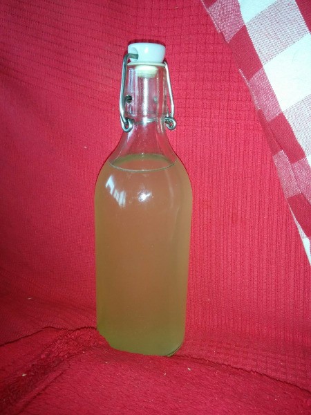 A bottle of homemade Miracle Orange Oil Cleaner.