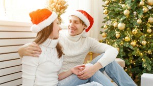 Boyfriend and Girlfriend sitting in front of Christmas tree