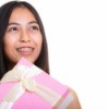 Close up of thoughtful young happy Asian teenage girl smiling while holding gift box
