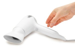 Woman hand reaching for a hairdryer