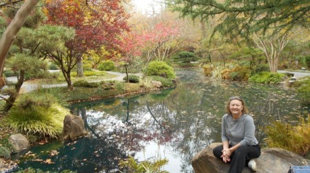 Fall Colorfest (Gibbs Garden, GA) - A woman seated by a pond with fall color.