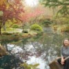 Fall Colorfest (Gibbs Garden, GA) - A woman seated by a pond with fall color.