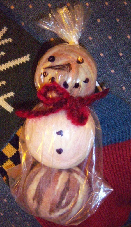 Dryer Ball Snowman Stocking Stuffer - three balls wrapped  in plastic bag and decorated to look like a snowman