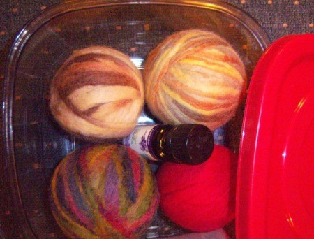 Dryer Ball Snowman Stocking Stuffer - container with balls of yarn and bottle of essential oil