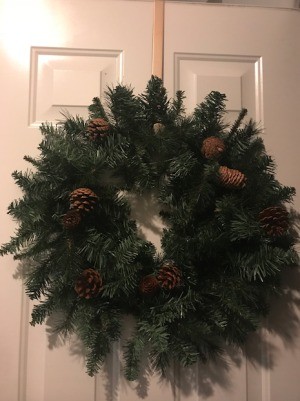 A Christmas wreath on a door.