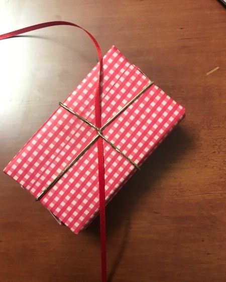 Present Wreath - use pieces of ribbon strung through the elastic on the bottom of gift to attach to wreath