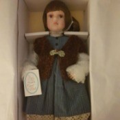 Value of Porcelain Jenny Doll - doll wearing blue dress and vest