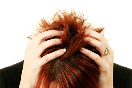 Woman grabbing the back of her head.