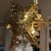 A light strand wrapped around a star tree topper.