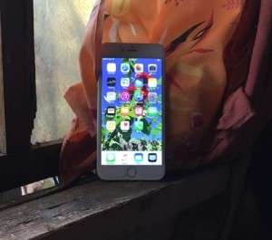 A smartphone against a window.
