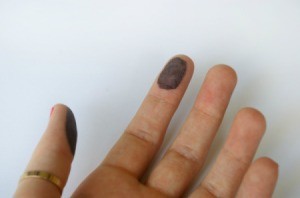 Hand with black fingerprint ink on 2 fingers.