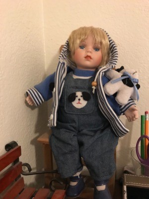 Identifying a Porcelain Doll - doll wearing a hoodie and overalls