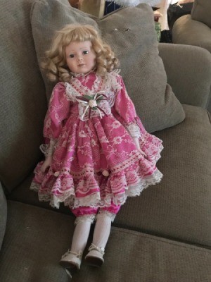 Identifying an Antique Porcelain Doll - blond doll with ringlets and wearing a pink and white floral dress