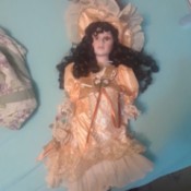 Identifying a Porcelain Doll - dark haired doll with apricot long dress
