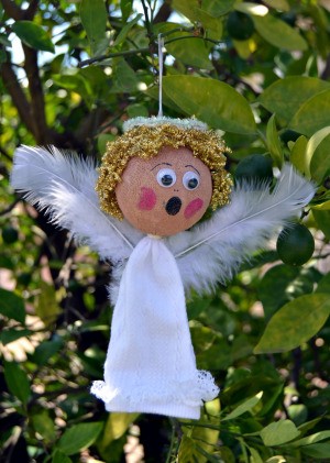 Lace Frill Sock Christmas Angel - finished angel with wings added hanging from a tree branch