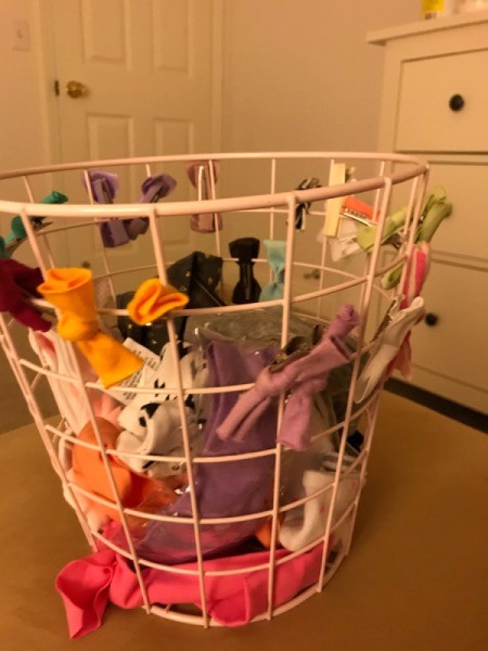 Using a wire waste basket to clip hair bows and accessories for organizing.