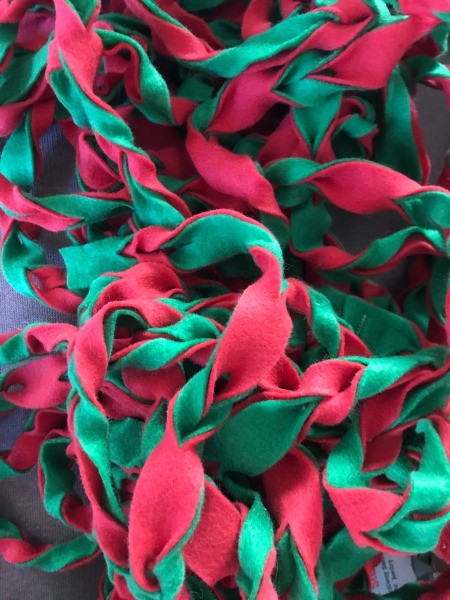 Easy Christmas Felt Garland or Bracelet - pile of garland before wrapping on stair railing