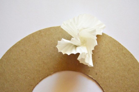 Christmas Eve Pillar Candle Decoration - make cupcake paper flowers and begin gluing to the wreath