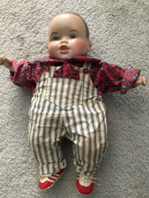 Identifying a Porcelain Doll - doll wearing a red print shirt and overalls