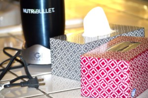 Tissue containers next to a Nutribullet appliance with a long cord.