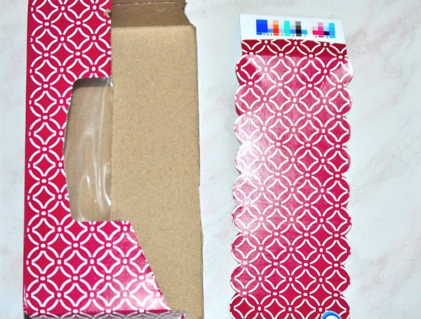 A recycled tissue box, cut into pieces.
