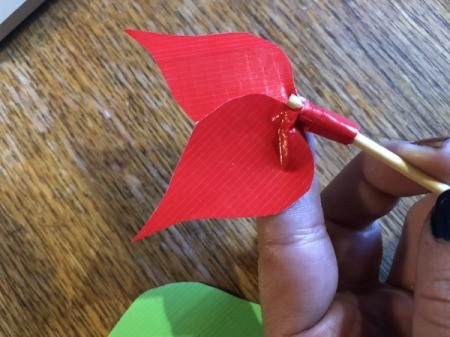 Making a Duct Tape Poinsettia - start with the smallest red leaves and wrap with tape to adhere to the stick