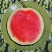 A small seedless watermelon, cut in half.