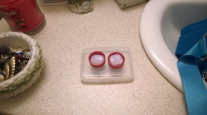 Two soda bottle caps with earplugs stored inside.