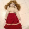 Identifying a Porcelain Doll - doll with fancy blouse, long red skirt, and red shoes