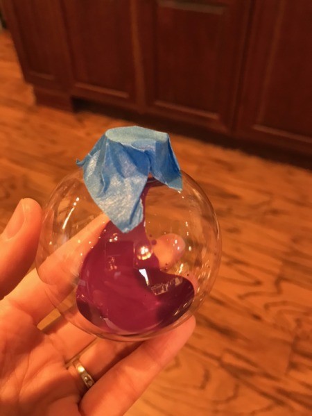 Poured Paint Ornaments - tape over ball with purple paint on bottom