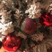 Poured Paint Ornaments - multicolored ball hanging on flocked tree