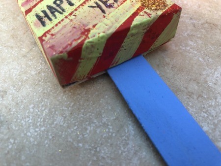 Snack Box New Year's Noisemakers - glue on a Popsicle stick handle