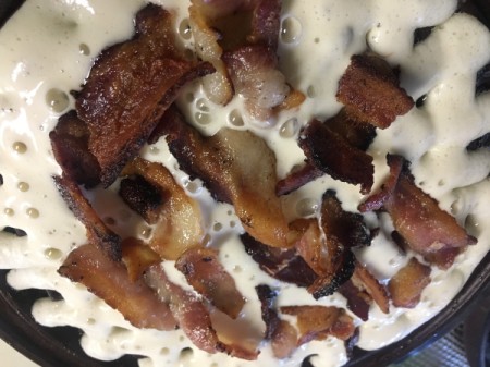 add bacon to thin layer of batter