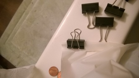 Binder clips to keep a shower curtain liner from billowing.