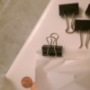 Binder clips to keep a shower curtain liner from billowing.