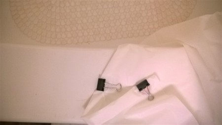Binder clips to keep a shower curtain liner from billowing.