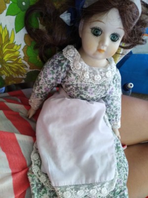 Identifying a Porcelain Doll - doll wearing a floral dress and apron