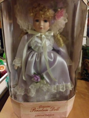 Value of Collectible Memories -
Reesa Porcelain Doll  - doll wearing a fancy white satin dress
