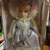 Value of Collectible Memories -
Reesa Porcelain Doll  - doll wearing a fancy white satin dress